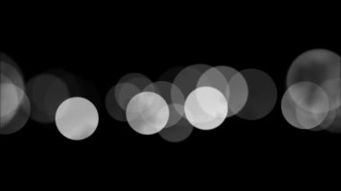 4K döngü Bokeh ışıkları Üst üste, zarif, hoş bokeh parçacıkları siyah döngü arka planı