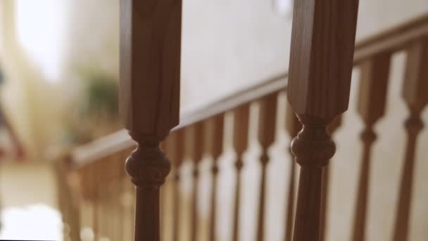 Woman climbing the stairs in the house and holding on to the handrail — Stock Video