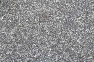 Tam bir çerçeve, ince taneli benekli bir dokunun yakın çekimi, granit, beton ya da taş bileşimine benzer..