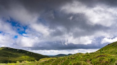 A stunning autumn landscape in the Bucegi Mountains, showcasing the Coltii Tapului mountain ridge. The vibrant fall colors paint the rugged terrain