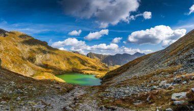 The breathtaking Capra Lake, nestled in the majestic Fagaras Mountains of Romania. A stunning summer landscape