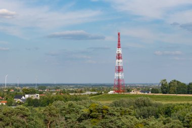 Wloclawek yakınlarındaki bir tepenin üzerinde rüzgar türbinleri ve arka planda manzarası olan bir radyo kulesinin editoryal görüntüsü. Tanınabilir simgeler dahil.