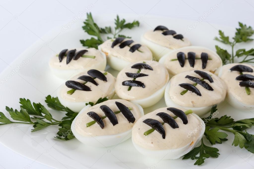 Eggs appetizer decorated as football