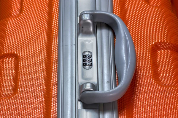 Used orange suitcase with code lock closeup — Stock Photo, Image