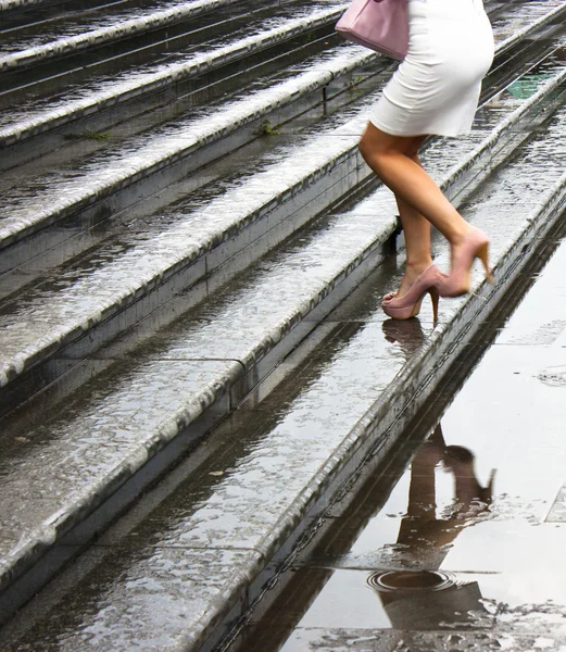 High heels going up the wet stairs