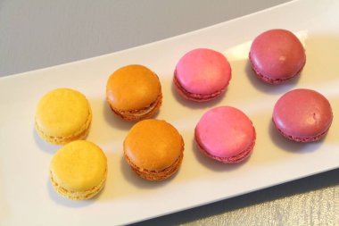 Beyaz bir tabakta meyveli badem kurabiyesi.