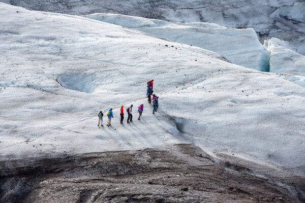 Glacier trekkers walk along