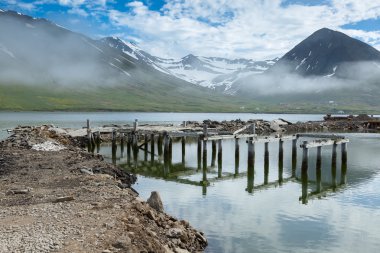 old jetty at the the coastline of Siglufjordur clipart