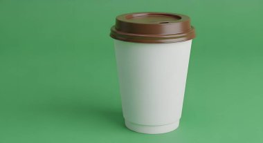 A simple white disposable coffee cup with a brown lid stands against a plain green background.