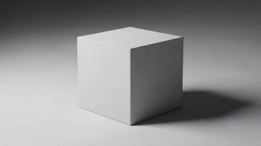 Gri bir yüzeyde, gölgesi olan izole edilmiş beyaz bir küp.