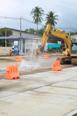 Bir karayolu inşaatı devam ediyor, açık havada ağır makineler ve ekipman sergileniyor ulaşım altyapısı ve otoyollar inşa etmek veya onarmak için çalışıyor.