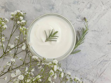 Kozmetik krem, çimento arka planda çiçek