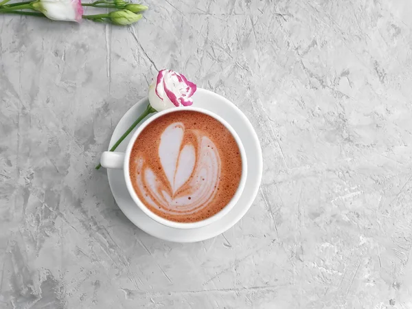 cup of coffee, rose flower on concrete background