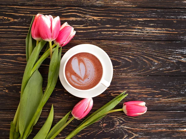 cup of coffee flower tulip on wooden background