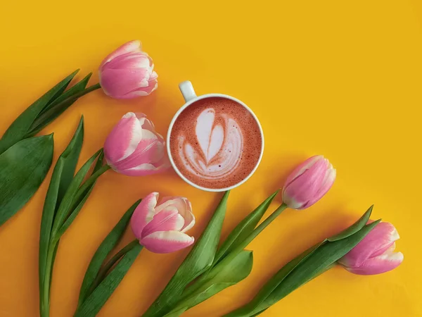 cup of coffee, flower tulip on a colored background