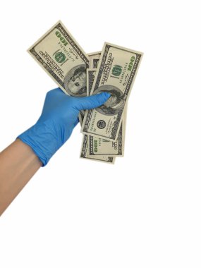 Tıbbi eldivendeki el dolar tutar.