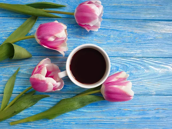 cup of coffee flower tulip on wooden background