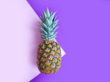 whole pineapple on a colored background