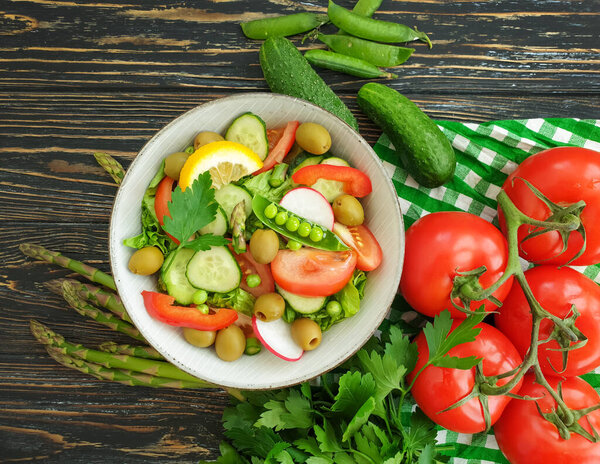 cucumber salad, tomato, green peas, olives