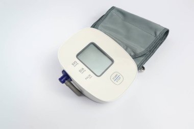 Compact electronic blood pressure measuring device with cuff for daily health monitoring, hospital and home use isolated on white. 