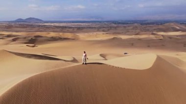 Peru 'daki Kum Tepeleri' nin Havadan Görüntüsü, Geniş Arazinin Ortasında Tek Başına Yürüyen.