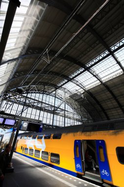 Amsterdam, Hollanda 'daki merkez tren istasyonundaki insanların uzun pozlama görüntüleri