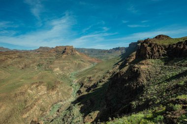 Büyük Kanarya Dağları 'nın nefes kesici panoramik manzarası dramatik tepeler yeşil vadiler ve açık mavi gökyüzü Kanarya Adaları' nın doğal harikası