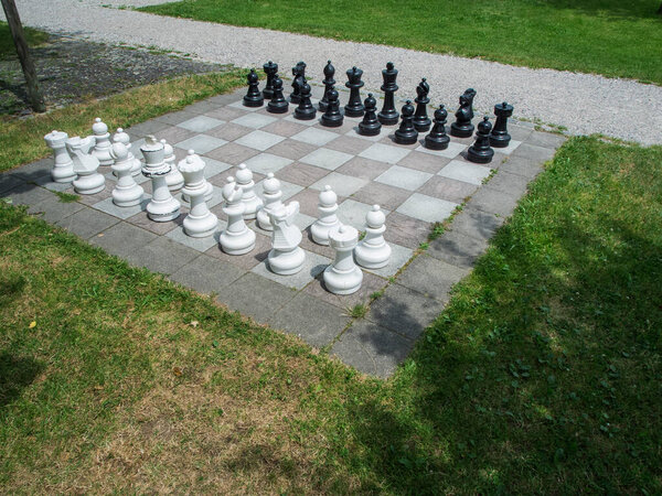 Outdoor chess game with playing pieces set up in a park in Bavaria.