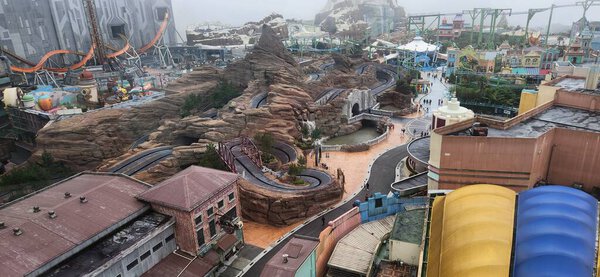 Aerial view of an amusement park with themed roller coasters and attractions in operation. March 19, 2025