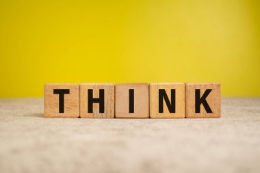 Sarı arka plandaki tahta bloklar hakkında düşün.