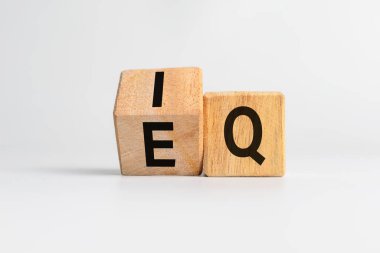 Beyaz arkaplanda izole edilmiş tahta küplere zeka katsayısı ve duygusal katsayısı veya IQ ve EQ harfi sembolü