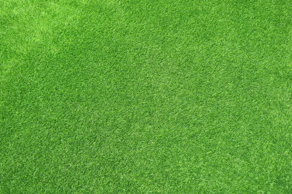 Canlı yeşil yapay çim dokusu, spor veya çimenlik için sentetik çimen arka planı.
