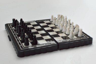 Temiz bir stüdyo ortamında seyahat, pratik ve masa üstü oyunu için ideal klasik bir strateji oyunu için zıt taşları olan kompakt katlanabilir bir satranç tahtası.