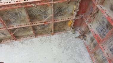 Yapılar inşa etmek için kullanılan endüstriyel beton biçimlendirme sisteminin yakın görüntüsü, modüler panelleri ve destek elementlerini gösterir