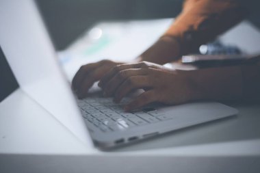 Business woman using calculator to calculate financial report, working at office with laptop computer on table. Asian female accountant or banker making calculations. finances and economy concept