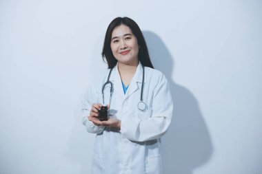 Tedavi için ilaç ya da ilaç tutan doktor ya da eczacı. Şişede antibiyotik hap var..