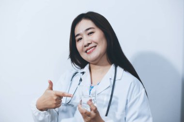 Beyaz stüdyo arka planında elinde kahve fincanı tutan Asyalı kadın portresi.