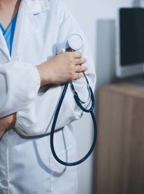 Elinde steteskop tutan genç bir erkek doktor.