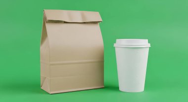 Yeşil arka plana kahverengi bir kese kağıdı ve beyaz bir kahve fincanı yerleştirilir. Çanta kapalı, bardak boş..