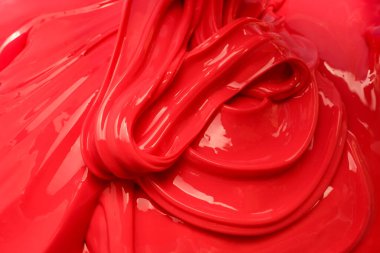 Pürüzsüz kıvrımları ve parlak bir yüzeyi olan parlak kıvrımlı kırmızı bir balçık. Özgeçmiş, reklam, doku ya da yiyecek ve güzellik ürünleri için mükemmel.