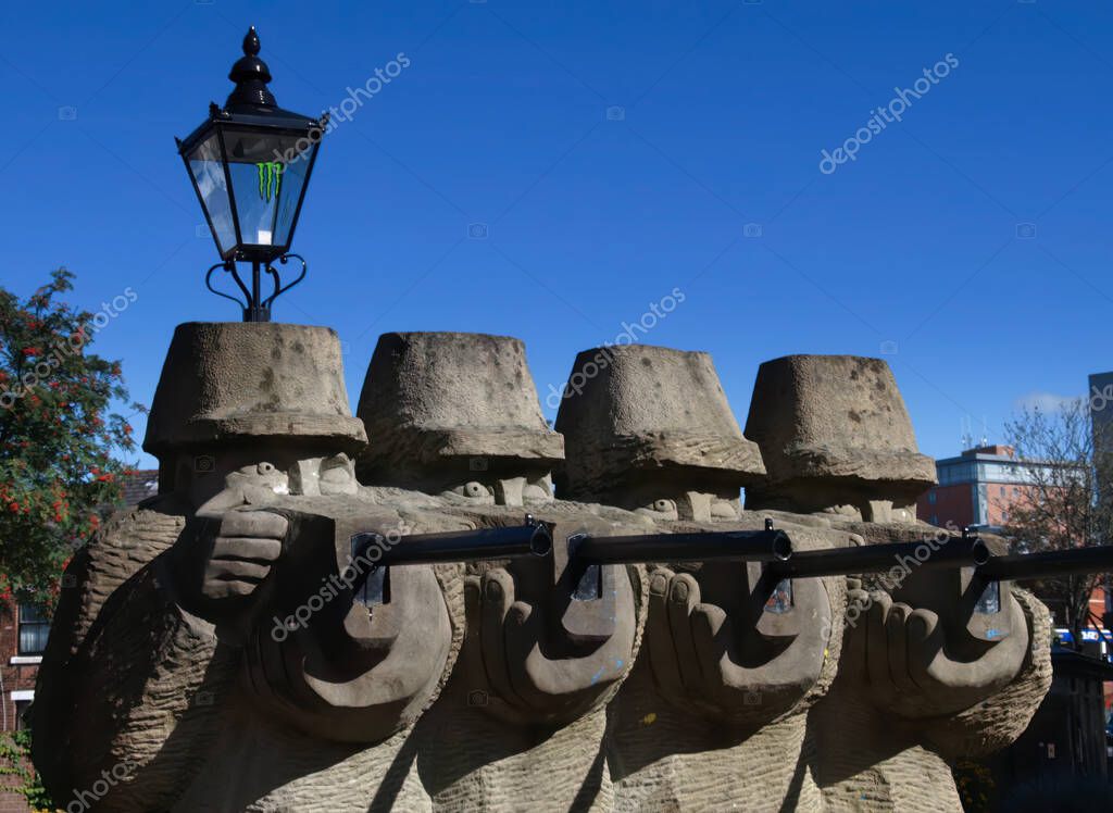 A solemn stone sculpture on Lune Street, unveiled in 1992, commemorates the murdered Preston cotton workers from a historic shooting.
