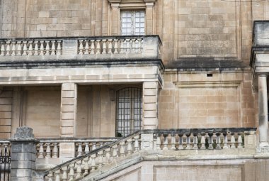 Ortaçağ Malta mimarisi. Uzun pencereleri ve balkonları olan bir binanın görüntüsü