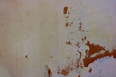 Eskimiş açık gri duvar, soyulmuş boya ve kahverengi alçı, çatlak ve erozyon izleri ile sıkıntılı şehir yüzeyi, eski beton duvar dokusu kırsal detaylar ve mimari, yenileme ve tasarım projeleri için kopya alanı