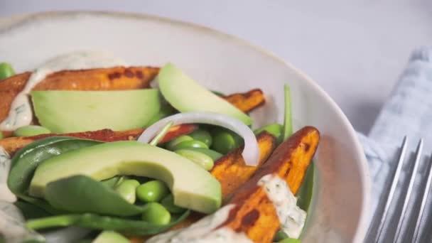 Vegan food concept. Baked sweet potato salad with avocado and edamame. — Stock Video