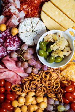 Şarküteri ve peynir tabağı. Çeşit çeşit et, peynir, meyve, zeytin ve krakerle aperatif tepsisi..