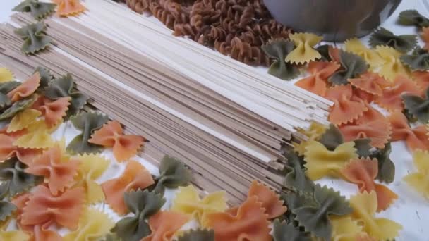 Different types of pasta. Raw noodles and spaghetti from rice, edamame, lentils, buckwheat and quinoa. — Stock Video