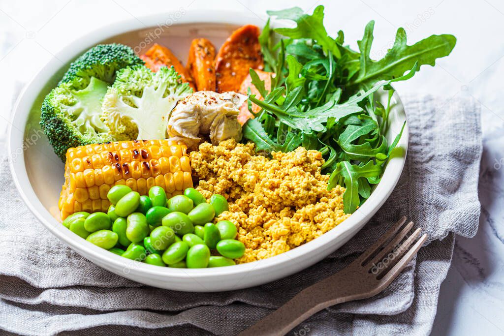 Vegan breakfast bowl - scrambled tofu, corn, beans, sweet potato and broccoli.