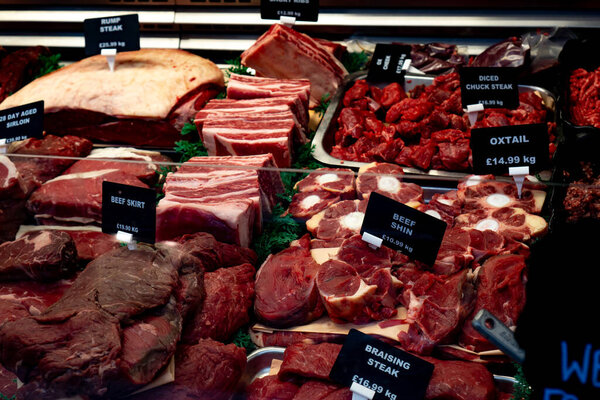Saffron Walden, Essex, UK - January 12, 2024: A display of various cuts of beef at a butcher shop in Saffron Walden, Essex including rump steak and oxtail.