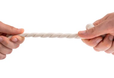 Two people pulling a rope in opposite direction isolated on white background. Male and female hands pulling white thread. Competition, conflict and arguing concept. Tug war, close up