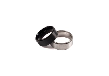 Two silver rings. White and black silver ring isolated on white background. Togetherness, wedding, love concept
